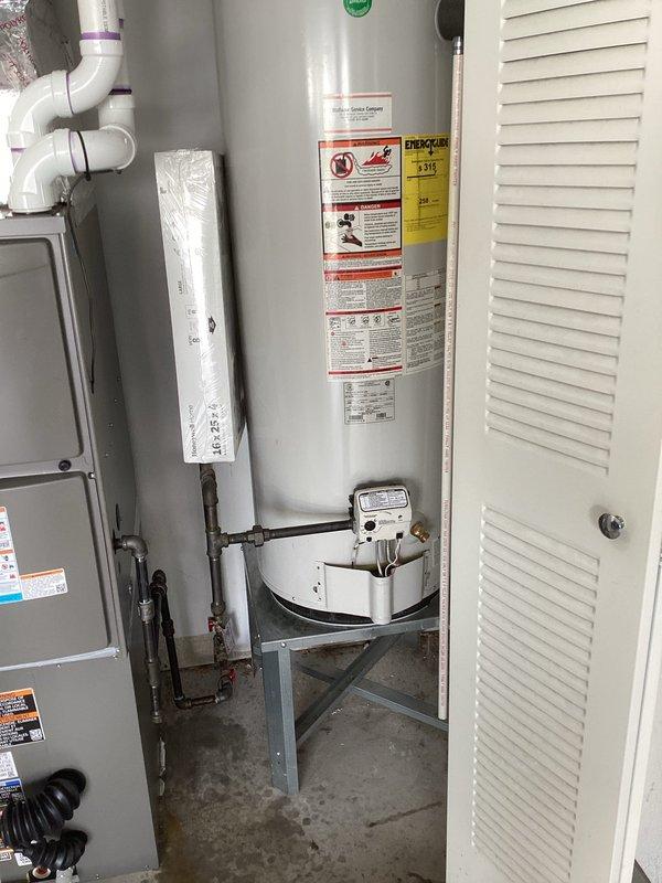 Responded to post-installation callback after city inspector reported gas odor at residence with recently installed natural gas furnace. Performed comprehensive gas leak inspection of furnace installation and surrounding gas appliances including water heater. Conducted pressure testing on all gas connections, checked furnace gas valve, supply piping, and flex connector joints. Inspected water heater gas connections and verified proper venting configuration for both appliances. All connections tested soap-bubble negative for leaks, no gas odor detected upon arrival or during inspection. Confirmed proper installation per code requirements and verified system operation. Documented installation with photos showing compliant furnace and water heater setup with appropriate venting and gas piping.