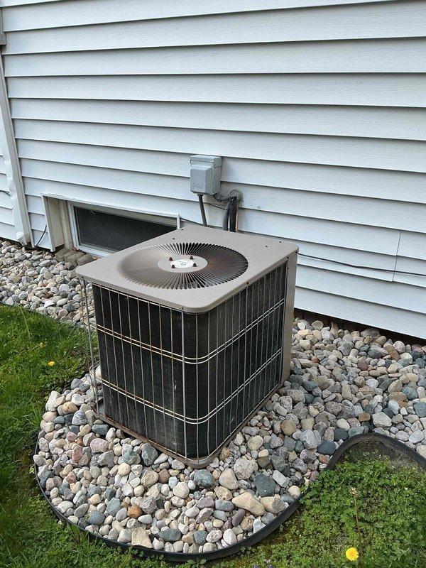 # HVAC Maintenance - Cooling

Performed comprehensive preventive maintenance on a 12-year-old residential air conditioning system. Conducted complete system inspection of outdoor condenser unit, including visual assessment of cabinet condition, coil cleanliness, and proper installation on rock bed foundation. Verified electrical connections at disconnect box, inspected refrigerant line insulation and conduit routing along exterior wall, and confirmed unit operational status. System found to be in functional condition with no immediate service needs identified.