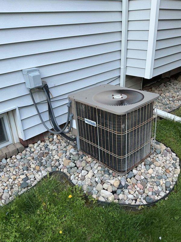 # HVAC Maintenance - Cooling

Performed comprehensive preventive maintenance on a 12-year-old residential air conditioning system. Conducted complete system inspection of outdoor condenser unit, including visual assessment of cabinet condition, coil cleanliness, and proper installation on rock bed foundation. Verified electrical connections at disconnect box, inspected refrigerant line insulation and conduit routing along exterior wall, and confirmed unit operational status. System found to be in functional condition with no immediate service needs identified.