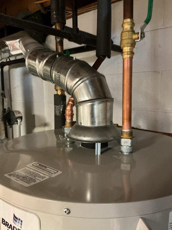 Reconnected tanked water heater with proper plumbing connections and venting. All copper supply lines, shut-off valves, and flue pipe were secured and verified for level installation. System tested and confirmed operational.