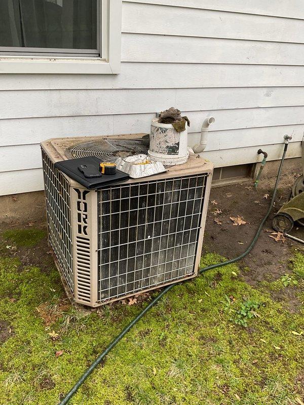 Conducted comprehensive assessment of existing York HVAC system for replacement estimate. Evaluated indoor furnace unit located in basement mechanical room and outdoor York condensing unit positioned on exterior grade. Documented current equipment configuration including gas furnace with PVC venting, electrical connections, refrigerant line sets, and condensate drainage. Photographed both indoor and outdoor components to record existing installation conditions, equipment placement, and utility connections for replacement planning purposes.