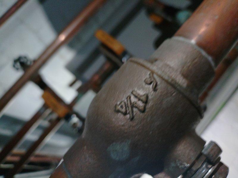Responded to service call for boiler system with reported leak from pipe above unit. Upon inspection, identified active water leak at copper piping connection near boiler assembly, specifically at valve body with multiple pipe branches. Documented existing plumbing configuration including Legend valve assembly and associated copper piping infrastructure for further assessment and repair recommendations.