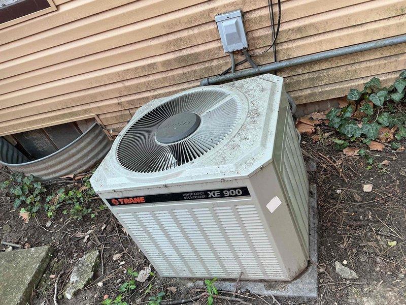 Completed comprehensive air conditioning tune-up on 38-year-old Trane XE 900 system. Performed standard maintenance protocol including inspection of outdoor condenser unit, indoor furnace components, ductwork connections, and electrical systems; noted significant age-related wear on equipment with accumulated debris on condenser coils and exterior surfaces requiring cleaning for optimal performance.