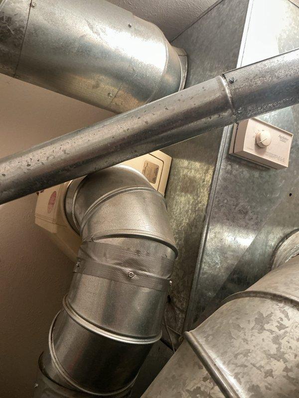 Performed comprehensive air conditioning tune-up on 20-year-old residential cooling system. Completed standard maintenance protocol including inspection of ductwork system, verification of airflow through main supply and return plenums, and assessment of mechanical components in utility area. System operational upon completion of preventive maintenance service.