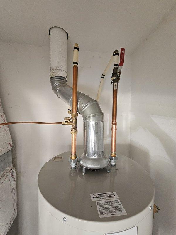 Installed 40-gallon tall tanked water heater in residential utility closet with proper expansion tank, copper supply lines, and PVC venting. Connected all hot and cold water lines with brass fittings, installed pressure relief valve with discharge piping, and secured unit on elevated platform alongside existing Lennox furnace. System tested and operational with no leaks detected.