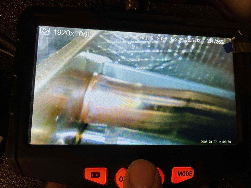 Performed cooling system maintenance and inspection on HVAC unit. Conducted internal diagnostic inspection using borescope camera to examine interior components, ductwork, and evaporator coil condition. Documented system condition with visual inspection images showing interior mechanical components and surfaces for maintenance records.