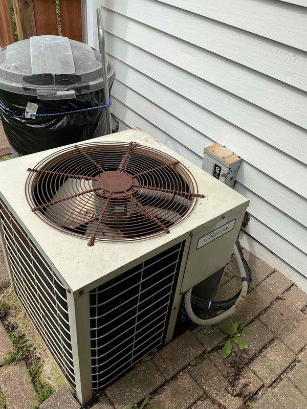 Completed comprehensive preventive maintenance tune-up on 30-year-old outdoor air conditioning condensing unit located in backyard. Performed standard inspection protocol including electrical connections, refrigerant levels, condenser coil cleaning, fan motor operation verification, and system performance testing. Unit showed significant age-related wear with rust present on fan guard assembly, though system remained operational within acceptable parameters for continued service.