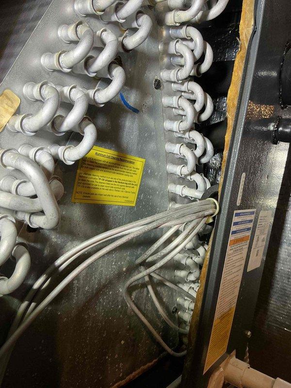 Completed comprehensive cooling maintenance on 6-year-old air conditioning system. Inspected evaporator coil assembly and heat exchanger components, noting normal condensation on coils during operation. Verified refrigerant lines, checked electrical connections, and confirmed all system components operating within manufacturer specifications.