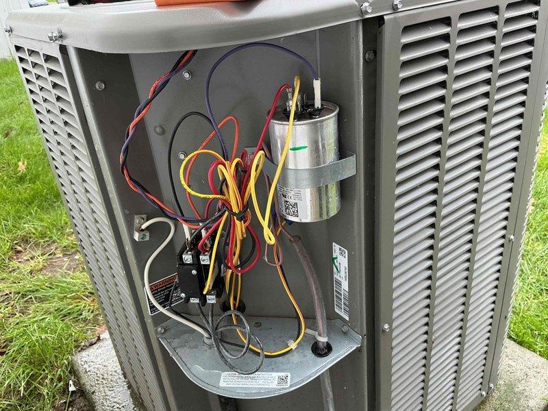 Responded to service call for 4-year-old air conditioning system that was not working and had frozen up prior to customer turning unit off at breaker on Saturday. Upon arrival, inspected outdoor condenser unit and internal components including capacitor and contactor. System had been off for sufficient time to allow ice to melt, enabling proper diagnostic evaluation of equipment and electrical connections to determine cause of freeze-up condition.