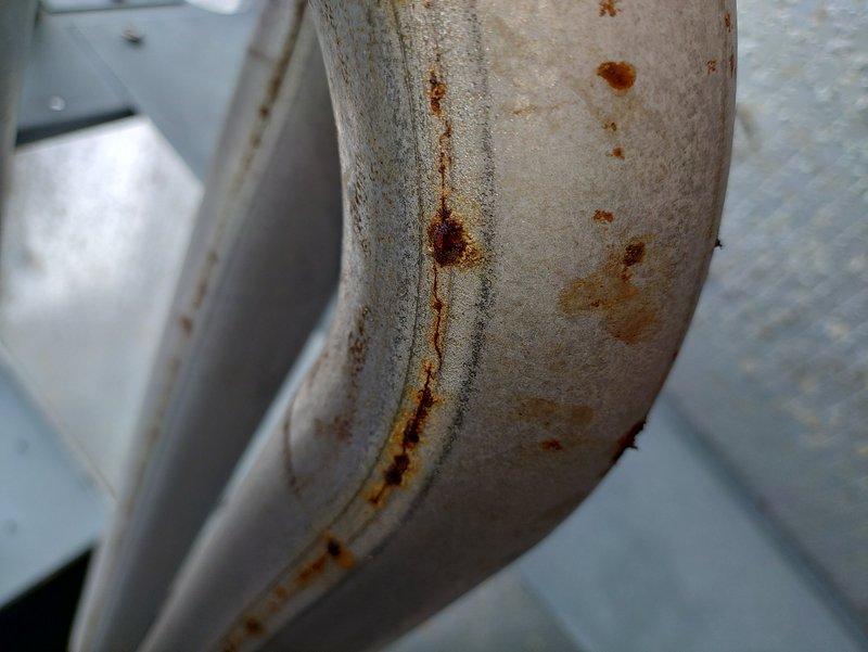 Responded to no-heat call for furnace system at church facility. Upon inspection, discovered severely corroded heat exchanger with extensive rust damage and surface deterioration along seams and welded joints. The furnace, over ten years old, exhibited compromised structural integrity of the heat exchanger due to prolonged moisture exposure and age-related oxidation. Documented the corrosion damage with photographs showing rust penetration and metal deterioration. Advised that the heat exchanger failure poses safety concerns and requires immediate attention, as continued operation could result in carbon monoxide hazards. Recommended full furnace replacement given the age of the unit and extent of heat exchanger damage.