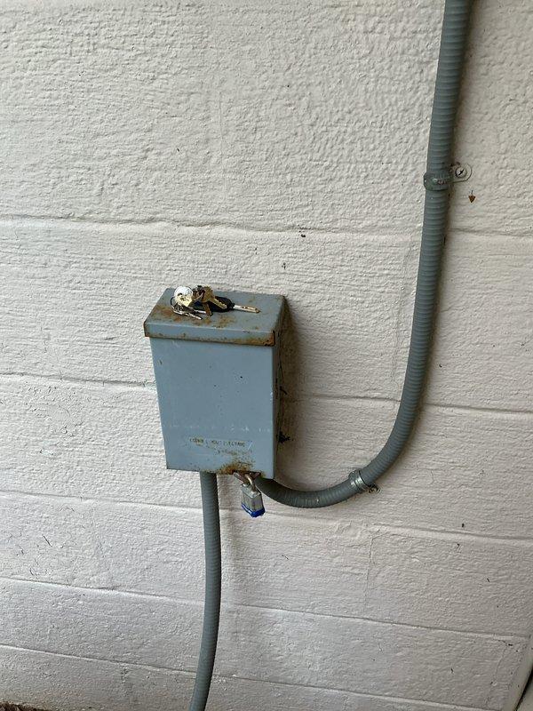 Completed annual air conditioning tune-up and preventative maintenance on 29-year-old cooling system. Inspected outdoor disconnect box and electrical components, noting visible weathering and rust staining consistent with age; all electrical connections remain functional and secure. Unit operational upon completion of scheduled maintenance service.
