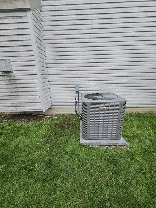 Completed installation of 14 SEER 4-ton package air conditioning system with upflow cased coil in attic space. Relocated condenser unit to opposite side of chimney, positioning on new concrete pad with proper clearances. Ran new 7/8" x 50' refrigerant lineset from outdoor condenser to indoor coil, properly insulated and secured with mounting brackets. Installed new electrical disconnect and whip for condenser power supply. Mounted condensate pump on wall adjacent to air handler to ensure proper drainage. Adjusted pitch on furnace exhaust vent at unit to ensure proper drainage and code compliance. Installed Honeywell T6 thermostat for system control. Verified all electrical connections, tested system operation, and confirmed proper refrigerant charge and airflow throughout the system.