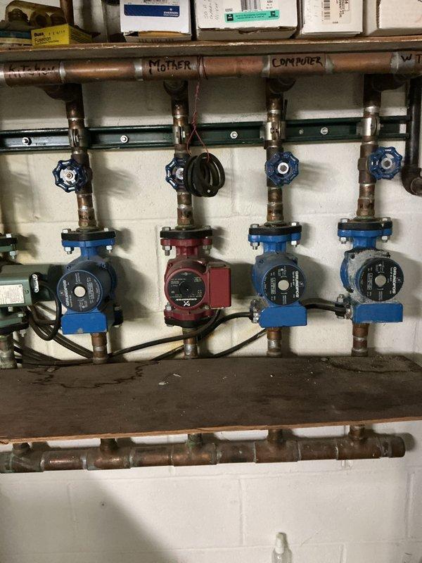 Performed annual maintenance on 30+ year old boiler system with multi-zone hydronic heating distribution. Inspected four-zone circulator pump manifold assembly, tested pump operation and verified proper function of zone isolation valves. Cleaned and serviced aged copper piping system showing moderate oxidation, confirmed all circulator pumps operational with proper flow rates. Removed and inspected heavily corroded aquastat control, recommended replacement due to significant rust deterioration affecting mounting bracket and electrical connections, though unit remains functional at this time.