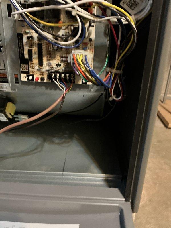 Completed comprehensive maintenance tune-up on a 20+ year old air conditioning system located on the right side of the residence. Performed thorough inspection of electrical control board, wiring connections, and all system components; verified proper operation of relays, capacitors, and terminal blocks; checked blower assembly and interior housing for functionality. Inspected exterior disconnect box and fuses, noting weathered condition with rust discoloration but confirmed components remain operational.