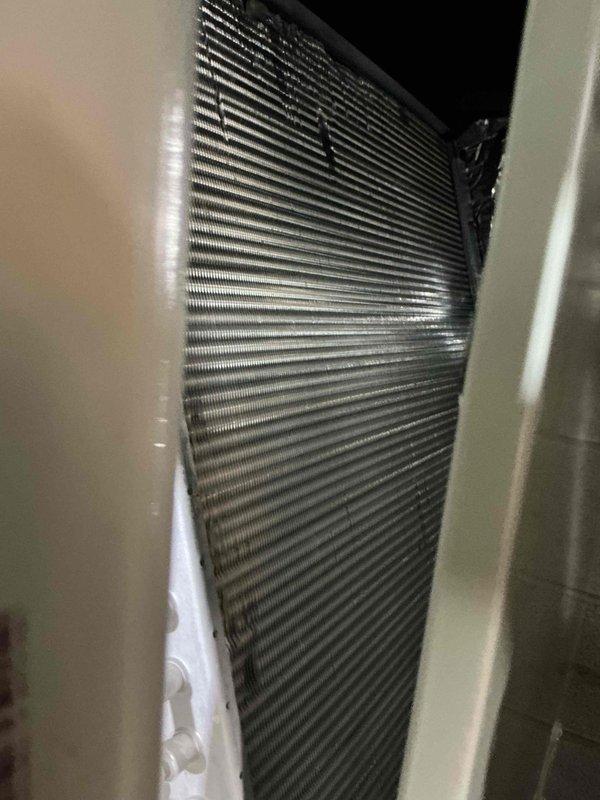 Completed complimentary AC maintenance service on residential cooling system. Inspected outdoor condenser unit with cylindrical configuration and indoor evaporator coil assembly, verified proper operation of all components, and documented system condition with photographs. Unit operational with no deficiencies noted at time of service.