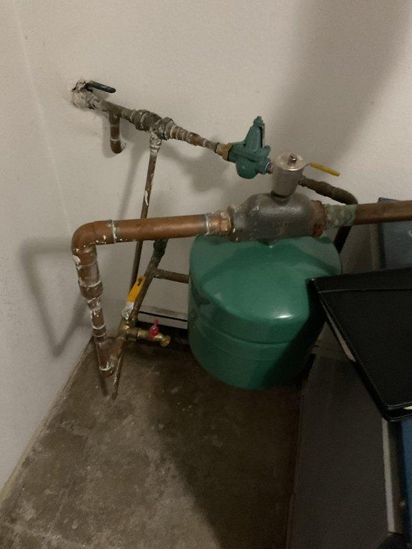 Conducted comprehensive boiler system assessment for existing customer, documenting current equipment condition and configuration. Evaluated blue residential boiler unit with associated copper piping, teal expansion tank, isolation valves, and galvanized venting system. Photographed all major components including plumbing connections, safety devices, and mechanical room layout to provide accurate estimate for replacement or repair recommendations.