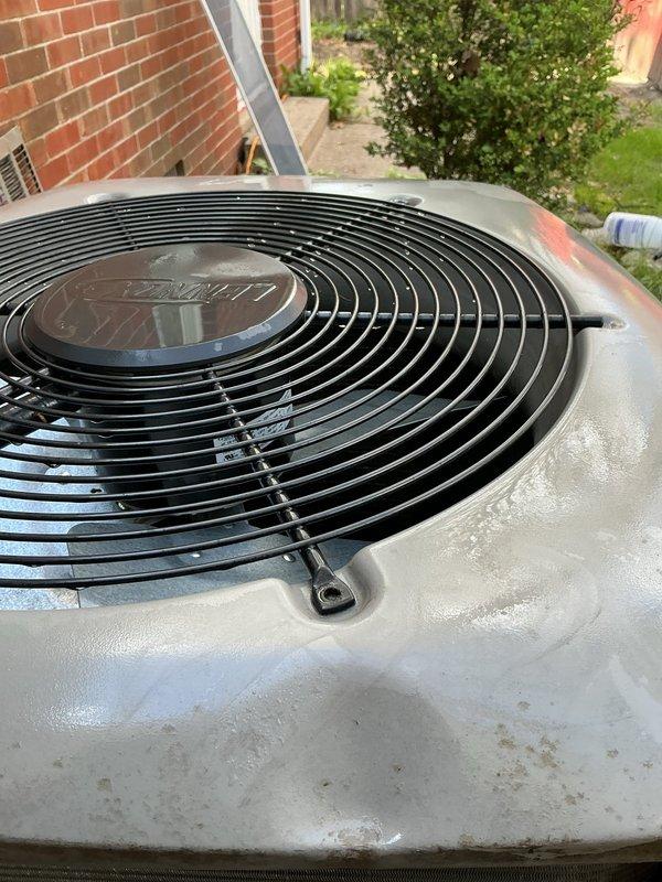 Responded to no cooling complaint on residential air conditioning system. Upon arrival, performed visual inspection of outdoor condenser unit which appeared to be in operational condition with clean fan grille and intact housing. Unit was documented with photos showing heat exchanger coils and outdoor installation on concrete pad. System requires further diagnostic testing to determine root cause of warm air discharge, as initial visual inspection did not reveal obvious mechanical failures or refrigerant leakage at condenser unit.