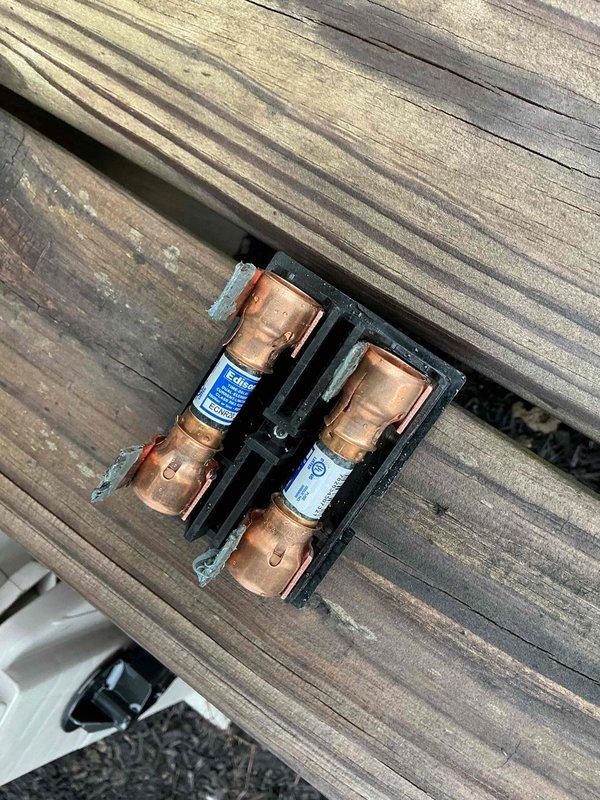 Completed spring maintenance and tune-up on a 3-year-old air conditioning system. Inspected and verified proper operation of electrical disconnect box with cartridge fuses, checked capacitor connections and wiring harness integrity, and documented system condition through photos. All components found in good working order with no immediate repairs needed.
