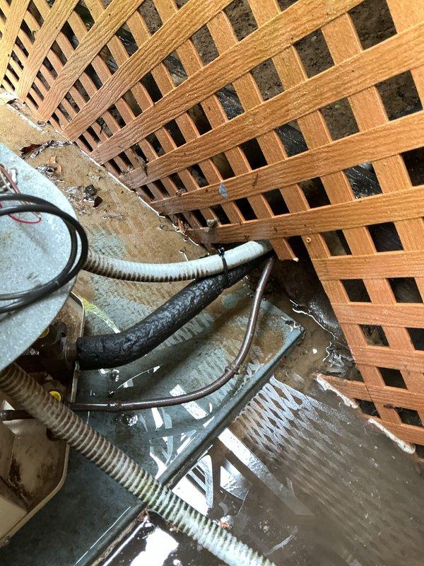 Performed comprehensive air conditioning tune-up on outdoor condensing unit located beneath deck lattice structure. Completed full system inspection including electrical connections, refrigerant levels, condenser coil cleaning, and operational testing to ensure optimal cooling performance for the upcoming season.