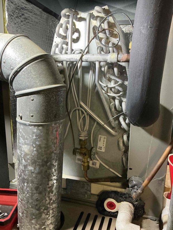 Completed comprehensive air conditioning tune-up on 5-year-old residential HVAC system. Performed standard maintenance protocol including inspection of evaporator coil, refrigerant lines, electrical connections, and condensate drainage system; all components found operating within normal parameters with appropriate condensation present on suction line indicating proper refrigerant charge and system operation.