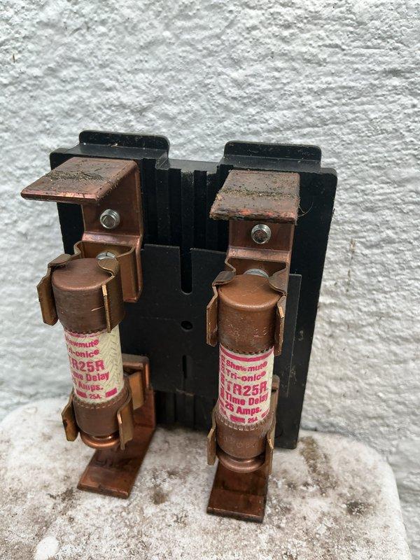 Completed scheduled maintenance on 2-year-old air conditioning system. Inspected and verified proper operation of electrical components including contactor, dual fuse assembly with TR25R time delay fuses, and control wiring connections. All components found in good working condition with normal wear patterns; system operating within specifications.