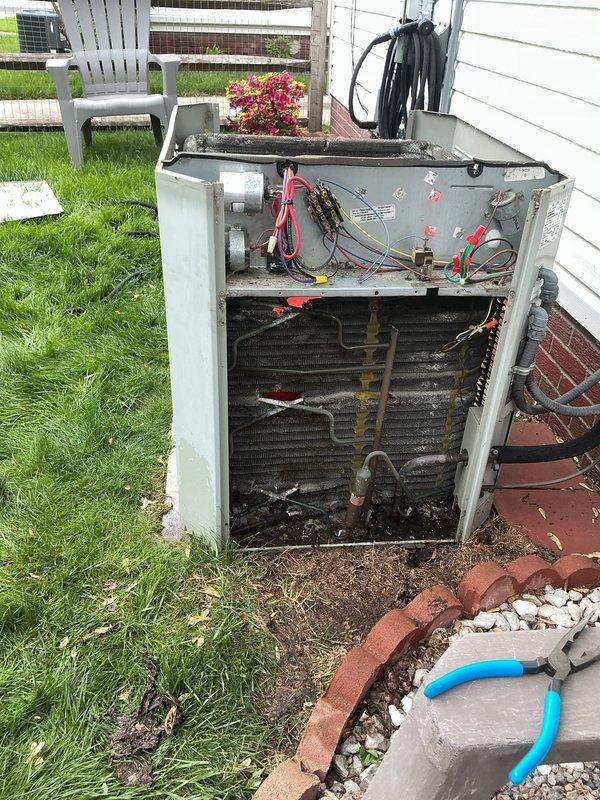 Completed routine air conditioning maintenance on residential outdoor condensing unit. Removed exterior panels to access and inspect internal components including condenser coils, refrigerant lines, electrical connections, and compressor assembly. Coils showed accumulation of dirt, debris, and organic material requiring attention. All wiring connections, copper refrigerant lines, and electrical components were visually inspected for proper operation and secure mounting.