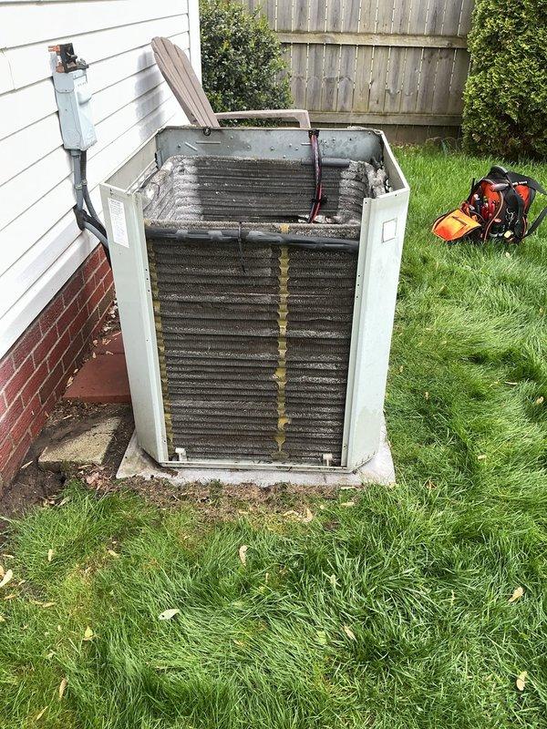 Completed routine air conditioning maintenance on residential outdoor condensing unit. Removed exterior panels to access and inspect internal components including condenser coils, refrigerant lines, electrical connections, and compressor assembly. Coils showed accumulation of dirt, debris, and organic material requiring attention. All wiring connections, copper refrigerant lines, and electrical components were visually inspected for proper operation and secure mounting.