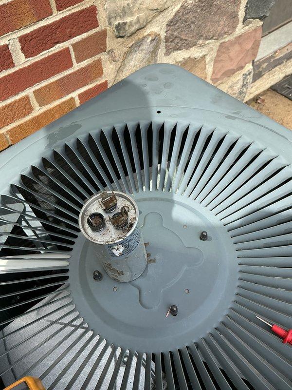 Completed preventative maintenance on 12-year-old air conditioning system. Inspected condenser fan assembly, electrical disconnect, and associated components; cleaned debris from outdoor unit and verified proper electrical connections at capacitor and disconnect box.