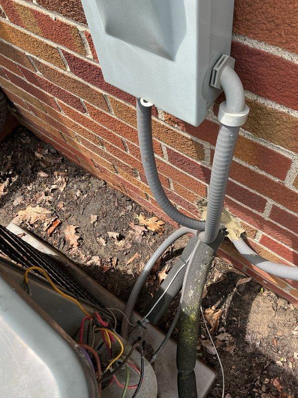 Completed annual maintenance on 1-year-old split system air conditioning unit with both lower and upper zones. Performed comprehensive tune-up including inspection of outdoor Goodman condenser unit, verified proper operation of compressor and condenser fan, checked refrigerant levels and electrical connections, cleaned coils, and assessed overall system condition. Noted visible corrosion and weathering on exterior components and electrical connections; documented equipment condition with photos for customer records.