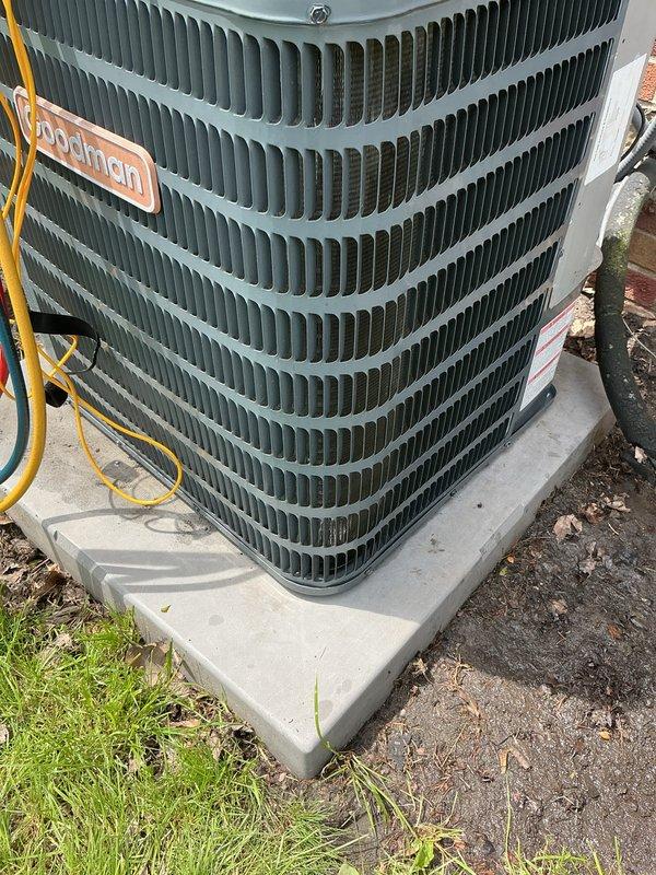 Completed annual maintenance on 1-year-old split system air conditioning unit with both lower and upper zones. Performed comprehensive tune-up including inspection of outdoor Goodman condenser unit, verified proper operation of compressor and condenser fan, checked refrigerant levels and electrical connections, cleaned coils, and assessed overall system condition. Noted visible corrosion and weathering on exterior components and electrical connections; documented equipment condition with photos for customer records.