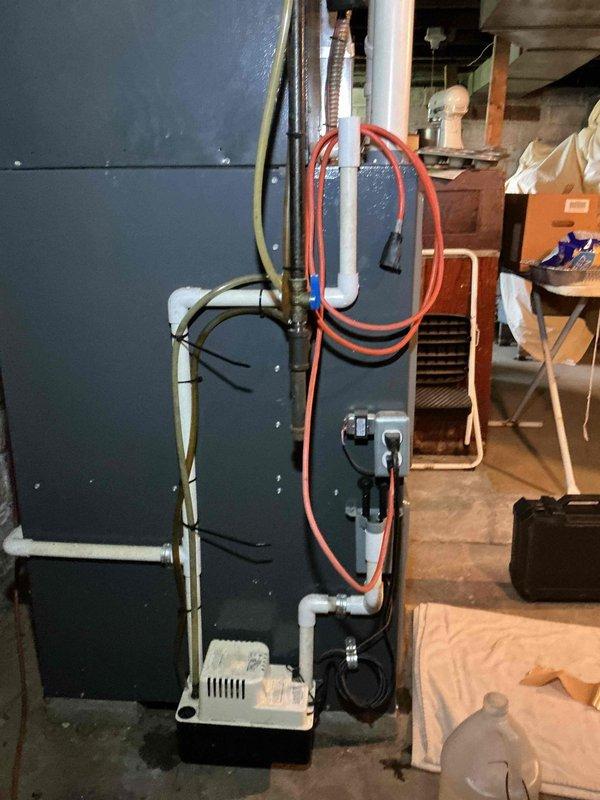Completed comprehensive spring maintenance on 15-year-old residential air conditioning system. Performed full system inspection including visual examination of indoor furnace/air handler unit, verified proper operation of condensate pump and drainage system, and inspected ductwork components. All equipment found operating within normal parameters with no immediate repairs required at time of service.