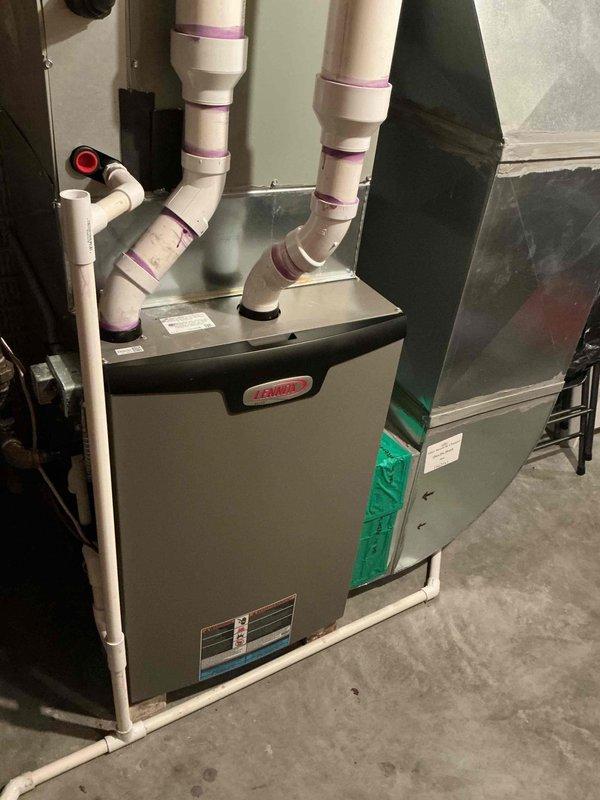Completed comprehensive AC tune-up on 2-year-old Bryant HVAC system. Performed standard maintenance protocol including inspection of furnace unit, verified proper operation of dual-run capacitor (45/5µF, 440V AC), checked all electrical connections, inspected condensate drainage system with PVC piping, and replaced air filter. All components tested within normal operating parameters with no deficiencies noted.