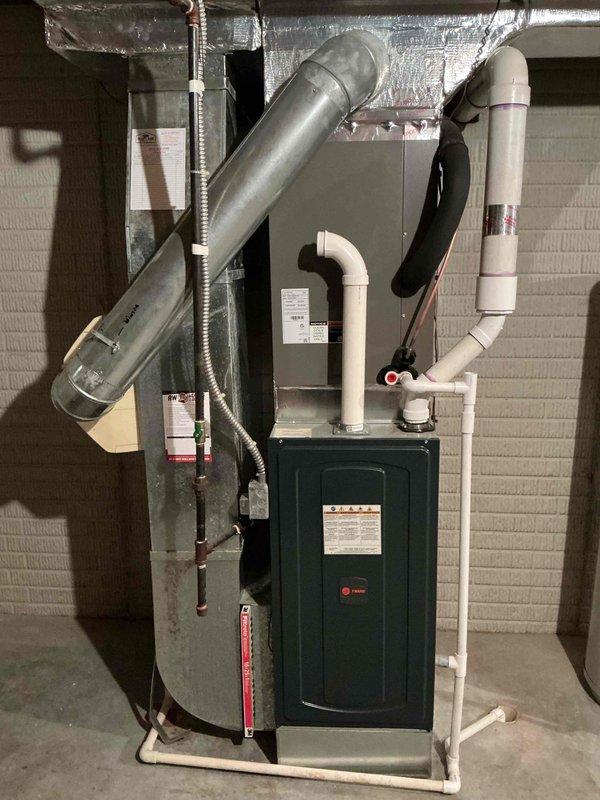 Performed routine cooling maintenance on a 2-year-old residential air conditioning system. Inspected furnace, air handler, and associated ductwork in basement installation; verified proper operation of electrical components including dual capacitors and control wiring; checked refrigerant lines and condensate drain system. All components found operating within normal parameters with no issues identified.