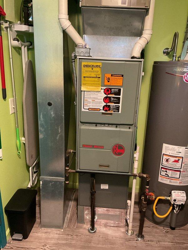 Conducted on-site evaluation for complete air conditioning system replacement at residential property. Assessed existing Rheem furnace, air handler, and associated HVAC equipment in utility room to determine compatibility and requirements for new AC installation. Documented current electrical panel configuration and circuit availability to ensure adequate power supply for replacement system, noting existing furnace circuit and available breaker capacity for new condensing unit connection.