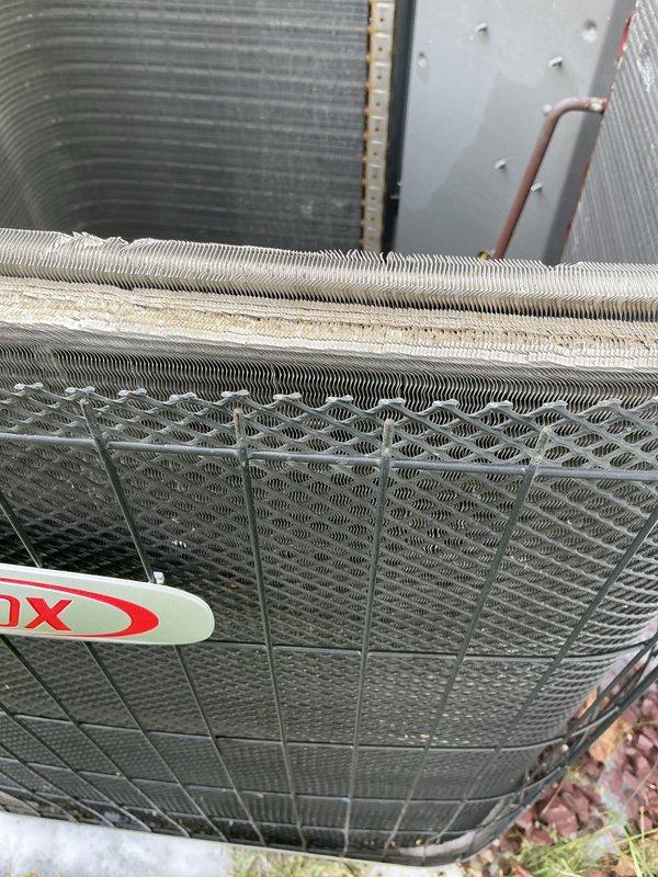 Performed routine cooling maintenance on 19-year-old air conditioning system. Inspected outdoor condenser unit and noted significant dirt and debris accumulation on coil fins. Replaced indoor air filter with new pleated filter to ensure proper airflow and system efficiency. Unit operational and ready for cooling season.