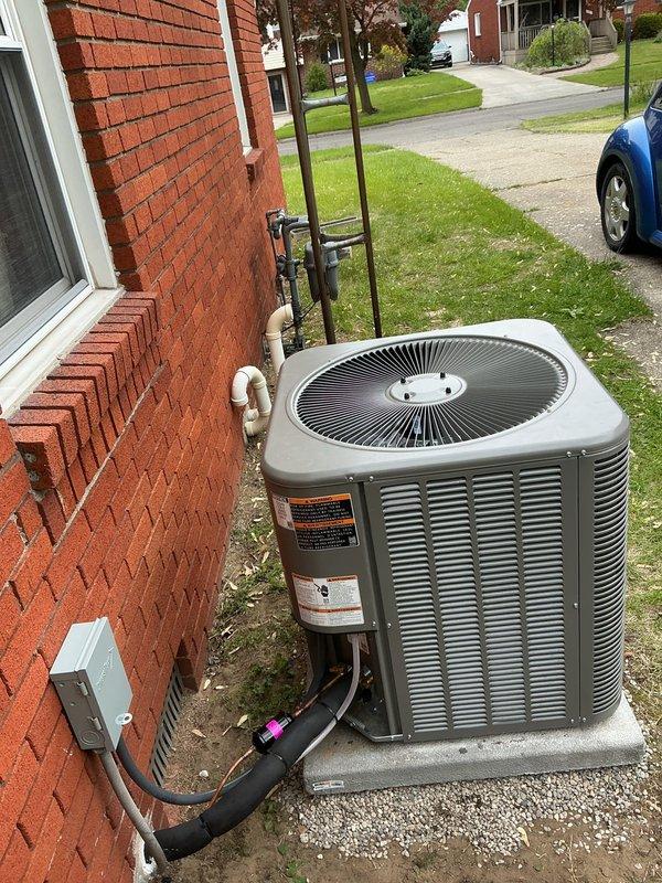 Completed full HVAC system installation in crawl space application, including horizontal configuration 96% efficiency 70,000 BTU gas furnace with matched horizontal cased evaporator coil. Installed drain pan with integrated flood control device for condensate management and safety protection. Ran new 3/4" x 30' refrigerant line set from indoor coil to outdoor single-stage condenser unit, ensuring proper refrigerant circuit connectivity. Set outdoor condenser on new concrete equipment pad with proper leveling and positioning for optimal airflow and drainage. Installed new electrical disconnect switch and whip for code-compliant power supply to outdoor unit. Mounted L-40 programmable thermostat for system control and completed all electrical connections. Secured refrigerant lines to exterior brick wall with appropriate mounting brackets and insulation. Verified all connections, performed system startup, and confirmed proper operation of heating and cooling cycles.