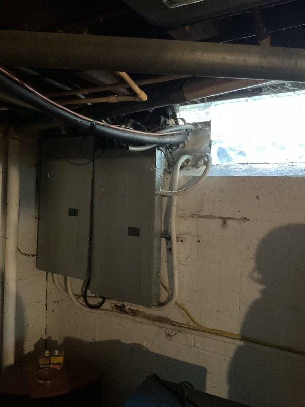Conducted comprehensive assessment of existing HVAC system in residential basement mechanical room for furnace replacement estimate. Evaluated current beige-colored furnace unit including condition of ventilation components, ductwork connections, and overall system configuration. Documented existing equipment layout with two water heaters present in mechanical room, noting spatial considerations and clearance requirements for replacement unit installation. Assessed silver metal ductwork routing from furnace including flexible duct connections to determine compatibility with new equipment specifications. Photographed electrical panel locations and utility infrastructure on concrete block walls to identify power supply considerations for replacement furnace. Evaluated floor space and protective platform requirements for new unit placement. Obtained customer billing address information as requested to complete estimate documentation.