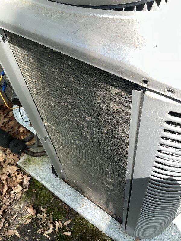 Performed scheduled cooling maintenance on 5-year-old residential air conditioning system. Inspected indoor air handler unit in basement, checking refrigerant lines, condensate drain system, and all electrical connections. Evaluated outdoor condenser unit, noting significant debris accumulation on coil fins and surrounding pad. Cleaned condenser coils to remove dirt, dust, and organic material buildup affecting heat transfer efficiency. Cleared leaves, mulch, and vegetation from concrete pad and unit base to ensure proper airflow and drainage. Verified all mechanical components, refrigerant piping insulation, and PVC condensate lines for proper operation and integrity. System operational upon completion of maintenance service.
