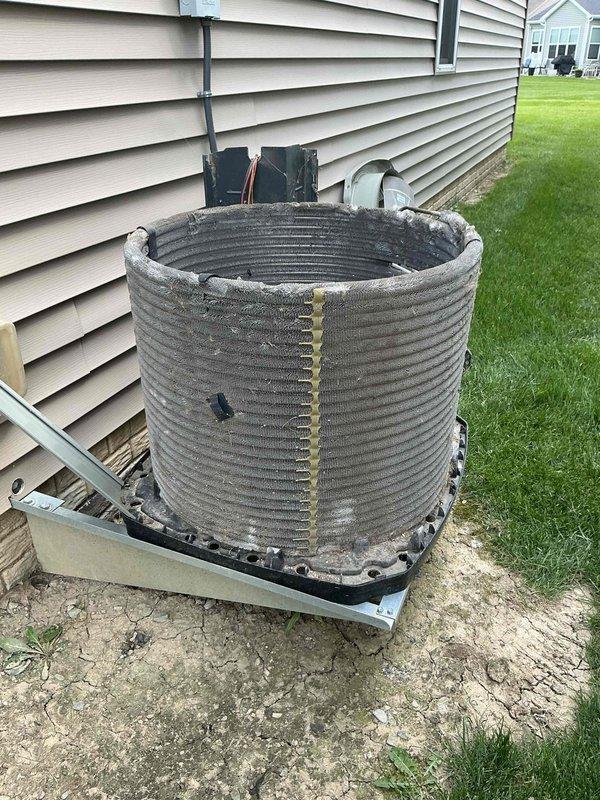 # HVAC Maintenance - Cooling Service

Performed comprehensive annual maintenance on a 13-year-old residential air conditioning system. Upon arrival, conducted visual inspection of outdoor condenser unit, noting accumulated dirt and debris on spiral-finned condenser coil and signs of age-related wear on components.

**Outdoor Unit Service:**
- Inspected condenser unit positioned on concrete pad adjacent to residence
- Evaluated condition of spiral-ribbed condenser coil, identifying significant dirt accumulation in fin grooves
- Cleaned condenser coil thoroughly to restore optimal heat transfer efficiency
- Checked refrigerant lines and electrical connections for integrity
- Verified proper operation of condenser fan motor
- Inspected electrical disconnect and service panel mounted on exterior wall
- Evaluated mounting platform and concrete pad condition
- Confirmed adequate clearance around unit for proper airflow

**Indoor Unit Service:**
- Accessed evaporator coil assembly and serpent