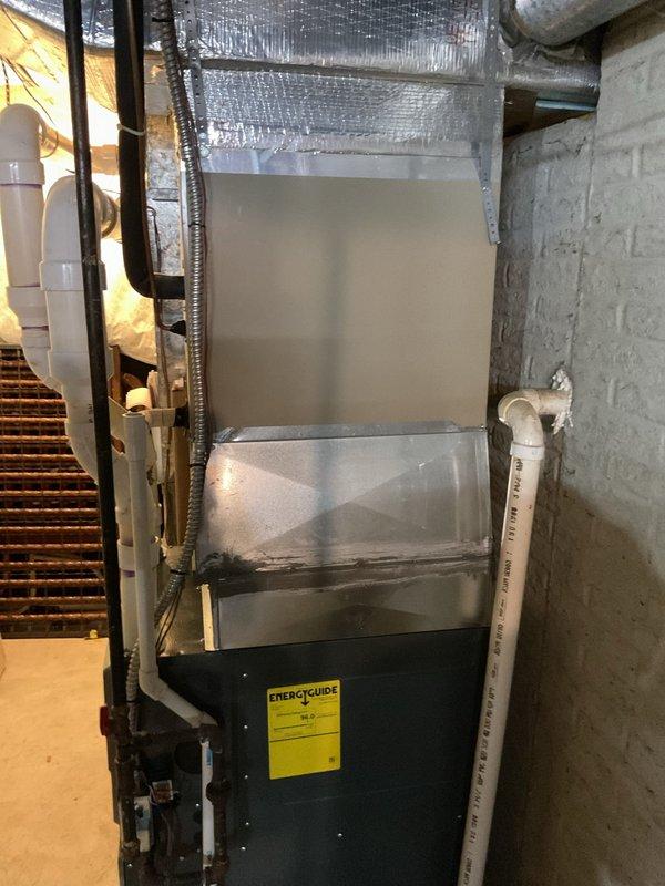 Conducted comprehensive assessment of existing HVAC system for complete air conditioning replacement. Evaluated current setup including dark green furnace/air handler unit in basement mechanical room with existing ductwork, insulation, and drainage systems. Inspected exterior condenser unit, electrical disconnect, and associated components. Documented equipment conditions, spatial constraints, and existing infrastructure to provide accurate replacement estimate for new AC system installation.
