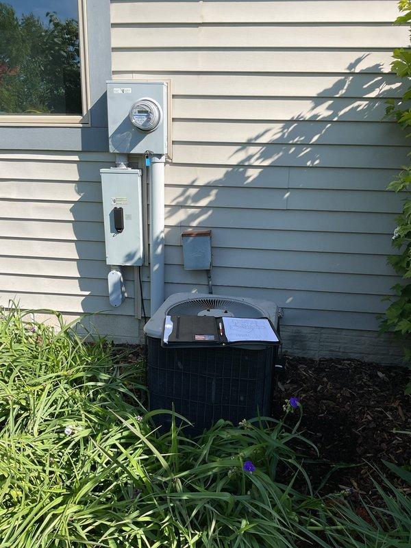 Conducted comprehensive assessment of existing HVAC system for complete air conditioning replacement. Evaluated current setup including dark green furnace/air handler unit in basement mechanical room with existing ductwork, insulation, and drainage systems. Inspected exterior condenser unit, electrical disconnect, and associated components. Documented equipment conditions, spatial constraints, and existing infrastructure to provide accurate replacement estimate for new AC system installation.