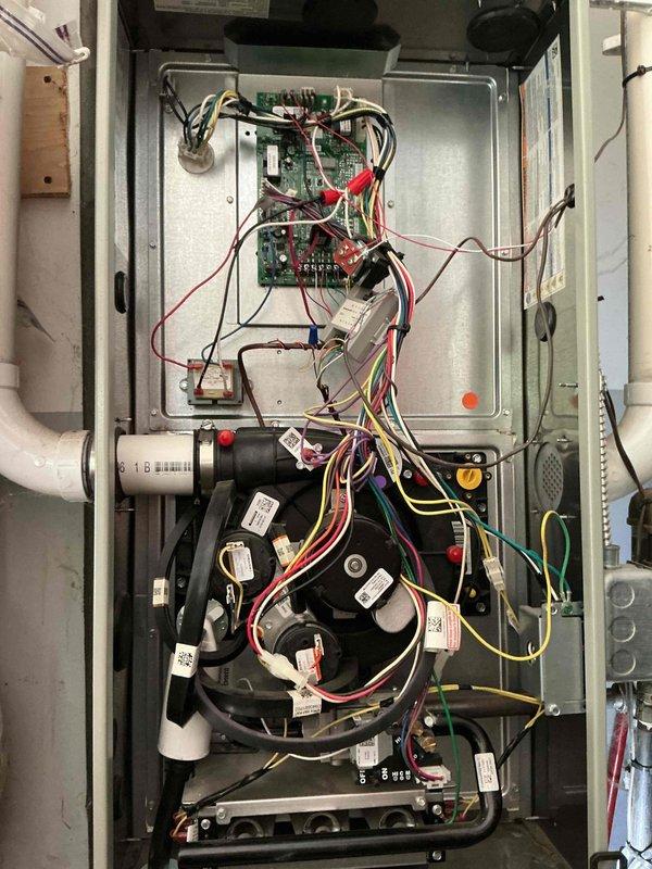 # HVAC Maintenance - Cooling System Service

Performed comprehensive preventive maintenance on a 4-year-old residential air conditioning system. Conducted thorough inspection of all major components including evaporator coil assembly, blower motor, electrical control panel, and refrigerant system connections.

Inspected evaporator coil for cleanliness and proper airflow, noting aluminum finned coil tubes in good condition with no visible debris accumulation or damage. Examined brass service valve assembly and verified refrigerant line connections for proper sealing and absence of leaks. Checked copper refrigerant lines for signs of wear, corrosion, or oil staining.

Opened electrical control panel and inspected all internal wiring, connections, and components. Verified proper wire terminations with secure wire nuts and twist connectors throughout the system. Examined capacitors mounted to blower motor assembly, confirming labels were legible and units showed no signs of bulging, leakin