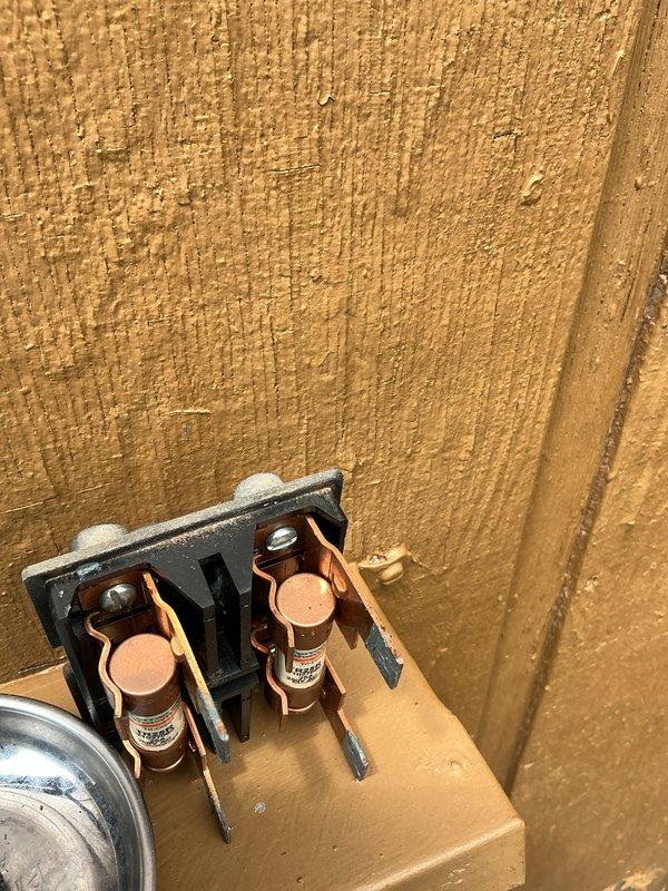 Performed annual air conditioning tune-up on a three-year-old system located in the basement. Inspected and tested electrical disconnect, verified proper fuse condition, and measured capacitor performance using digital multimeter to ensure optimal system operation.