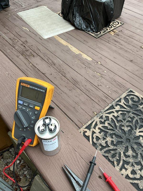 Performed annual air conditioning tune-up on a three-year-old system located in the basement. Inspected and tested electrical disconnect, verified proper fuse condition, and measured capacitor performance using digital multimeter to ensure optimal system operation.