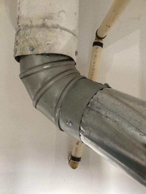 Responded to callback for water heater installation that failed city inspection due to improper piping configuration. Corrected plumbing connections on both hot and cold water lines, ensuring proper installation of copper piping with brass fittings and unions to meet code requirements. Repositioned and secured vent piping connections with appropriate elbow fittings and coupling bands, bringing the entire installation into compliance with municipal plumbing standards for re-inspection approval.