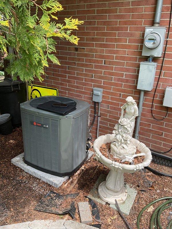 Conducted comprehensive site evaluation of existing residential air conditioning system for replacement estimate. Assessed outdoor condenser unit positioned on concrete pad against brick exterior, documented current equipment specifications, electrical service connections, and refrigerant line routing. Evaluated installation area accessibility, existing electrical infrastructure including meter location and conduit runs, and provided detailed recommendations for complete system replacement with proper sizing and configuration to meet cooling requirements.