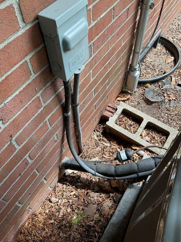 Conducted comprehensive site evaluation of existing residential air conditioning system for replacement estimate. Assessed outdoor condenser unit positioned on concrete pad against brick exterior, documented current equipment specifications, electrical service connections, and refrigerant line routing. Evaluated installation area accessibility, existing electrical infrastructure including meter location and conduit runs, and provided detailed recommendations for complete system replacement with proper sizing and configuration to meet cooling requirements.