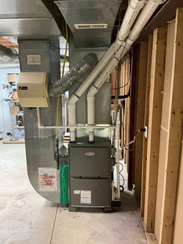 Completed installation of a 96% efficiency, 110,000 BTU furnace in basement mechanical room. Replaced approximately 70 feet of 3-inch venting system with new metal ductwork, routed from furnace through ceiling joists to exterior termination. Installed metal condensate pump with drainage tubing to handle condensation from high-efficiency unit. Reconnected existing thermostat to new furnace control board and verified proper operation. All gas connections, electrical wiring, and safety controls tested and confirmed operational per manufacturer specifications.