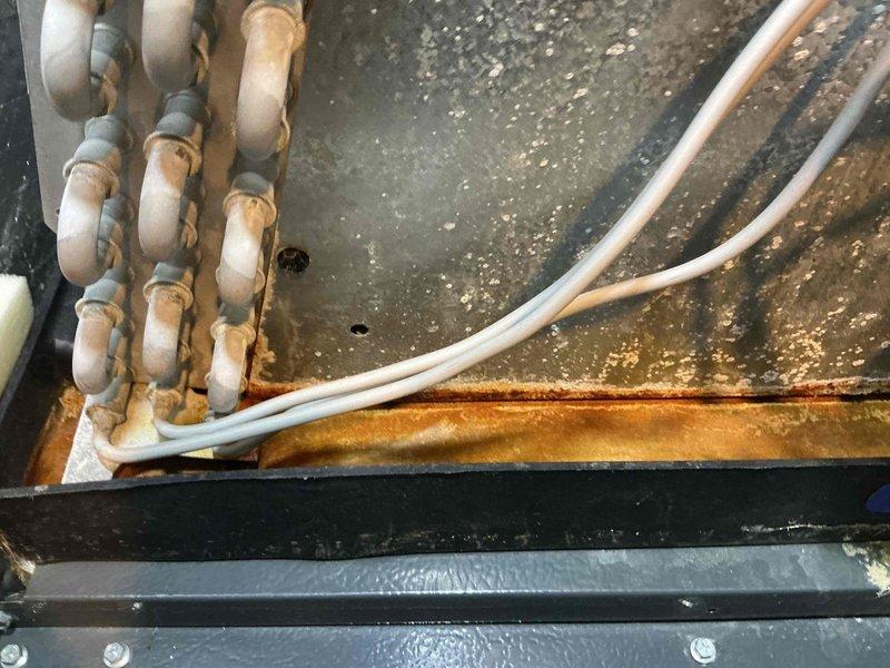 Completed routine cooling maintenance on 8-year-old air conditioning system. Upon inspection, discovered significant rust accumulation on refrigerant line connections and metal components within the unit, along with substantial dust and debris buildup on interior surfaces. Performed thorough cleaning of condenser coils and interior components, removed dust accumulation from metal panels, and inspected flexible ductwork and insulation in confined spaces using inspection camera to verify system integrity. Assessed corroded pipe fittings and rust deterioration on metal joints, which will require monitoring for potential future replacement to prevent refrigerant leaks and maintain system efficiency.