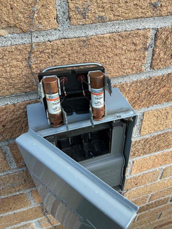 Completed routine cooling maintenance on a 2-year-old Lennox HVAC system. Inspected and verified proper operation of outdoor disconnect and fuse assembly, confirmed electrical connections secure with TR25R time-delay fuses in good condition. Evaluated indoor air handler and refrigerant line connections, documented equipment condition with all components functioning within normal parameters.